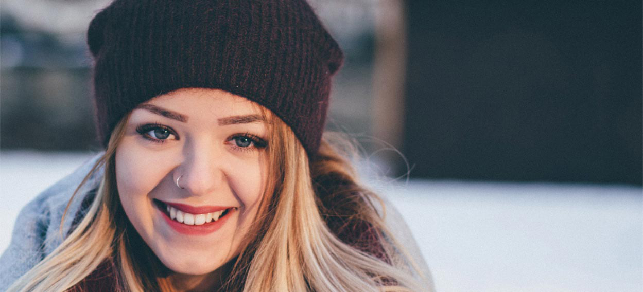 Grinning woman with a winter hat on